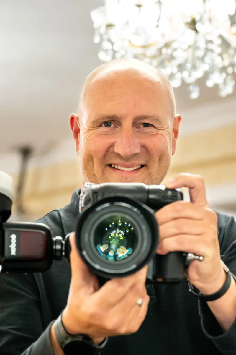 Mark, founder of StudioApp, holding his camera